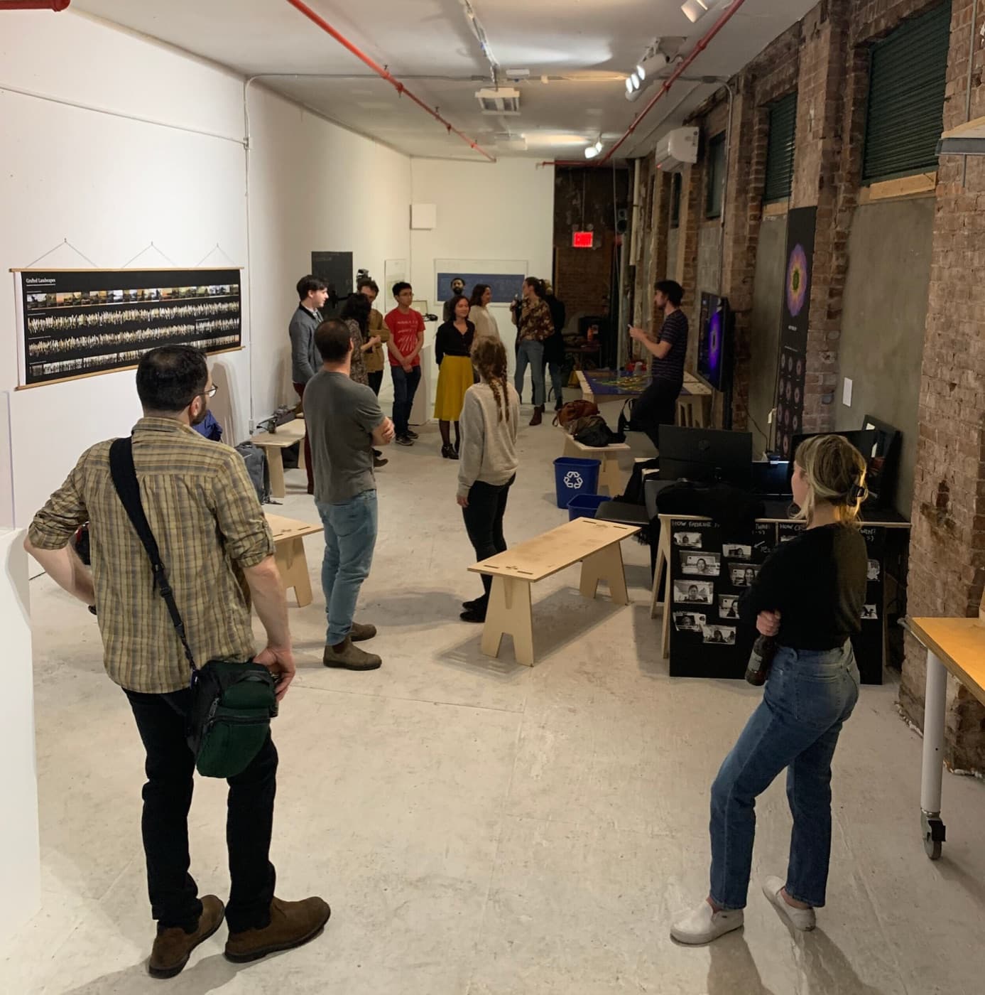 Participants standing among the artworks in the DxD 2020 gallery during Data Dialogues